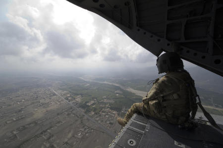 With combat resupply missions running daily, and troops being moved around the country, I often found myself aboard the most common mode of travel, a helicopter. Seated on the back of a Chinook helicopter ramp, a member of the helicopters crew keeps a watchful eye for any threats that might arise. Threats to the aircraft can be from enemy fire or from obstacles the pilots cannot see. These crewmembers also handle making sure that passengers approach the aircraft in a safe manner.
Published by National Geographic.