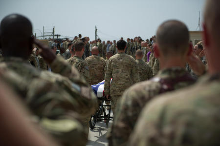 As the detail passed down the ranks, the soldiers individually saluted their fallen comrade. The pace was slow, and reverent. A UH-60 Blackhawk helicopter from the 10th Mountain Division sat on the helipad. The detail approached the Blackhawks rear door. The crew chiefs saluted, and held their salute as the wheels of the stretcher were removed. The detail preformed a 180 degree turn, placing the head of the fallen solder into the Blackhawk first. The Chaplain asked the assembly to kneel in prayer. The soldiers took a knee. With eyes closed, the Chaplain placed his hand on the flag, and held his right hand out as he prayed.
Published by National Geographic.